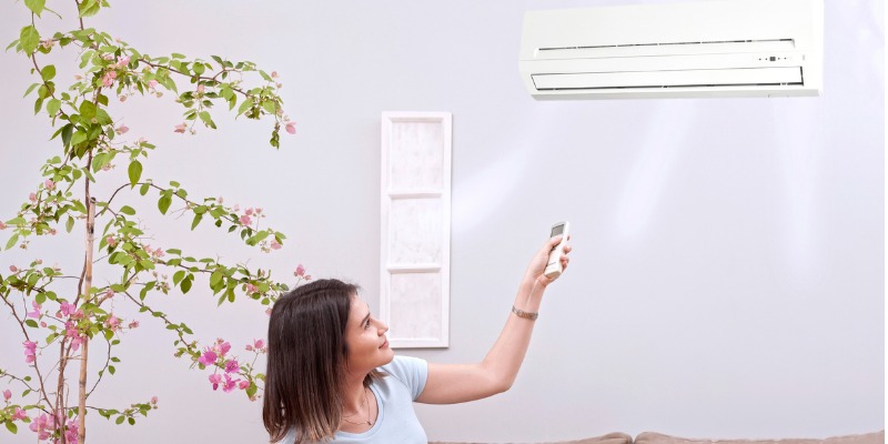 Woman Using Remote Control Air Conditioner Picture Id1080302448 1
